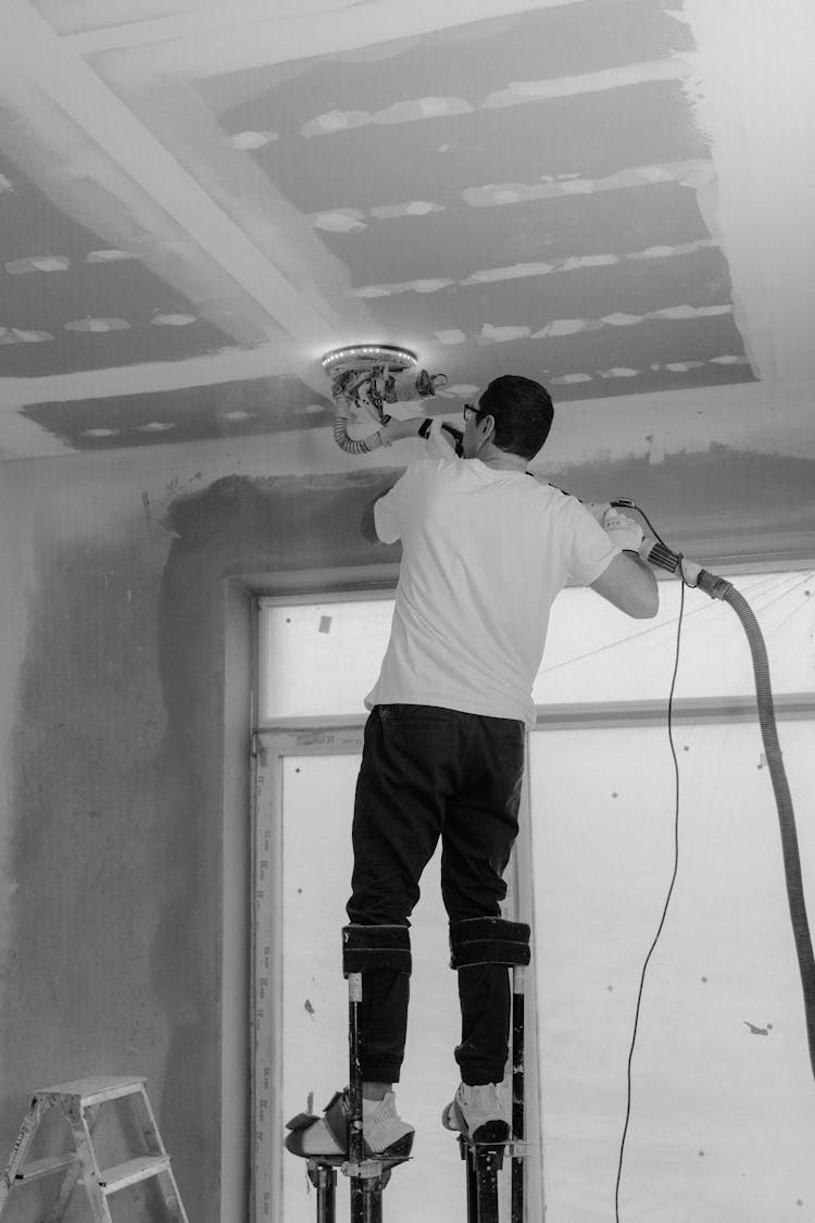 Man Polishing The Ceiling