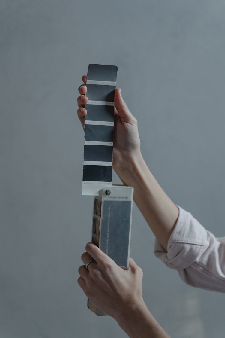 A Person Holding A Swatch Of Color Samples