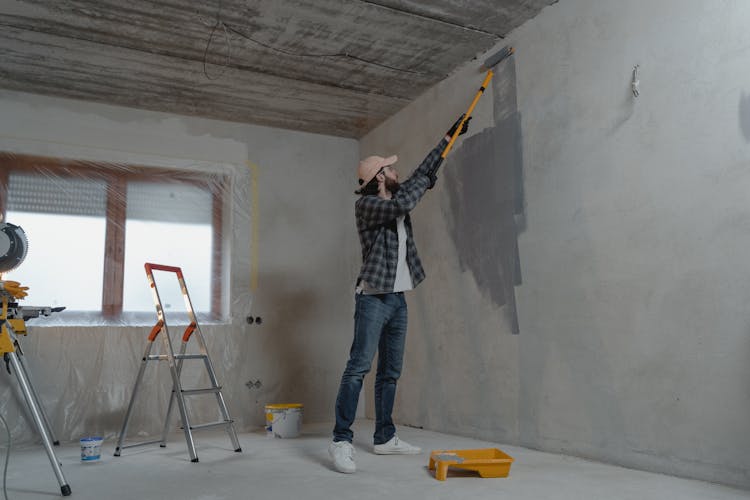 Man Painting The Wall