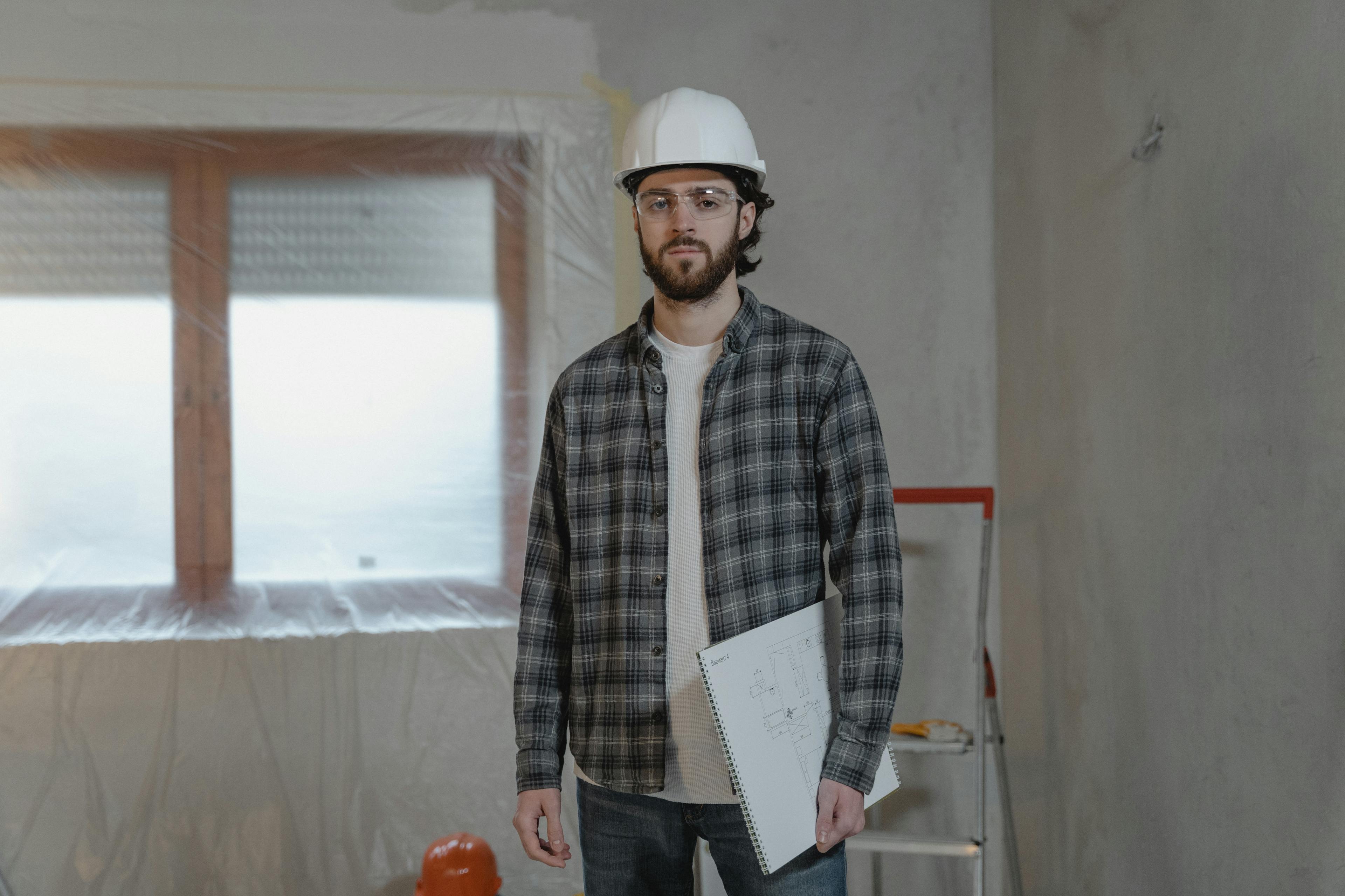 Man in White and Black Plaid Dress Shirt Holding White Printer Paper