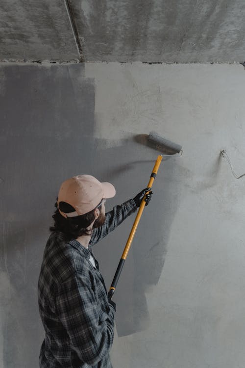 Free Man Painting the Wall Stock Photo