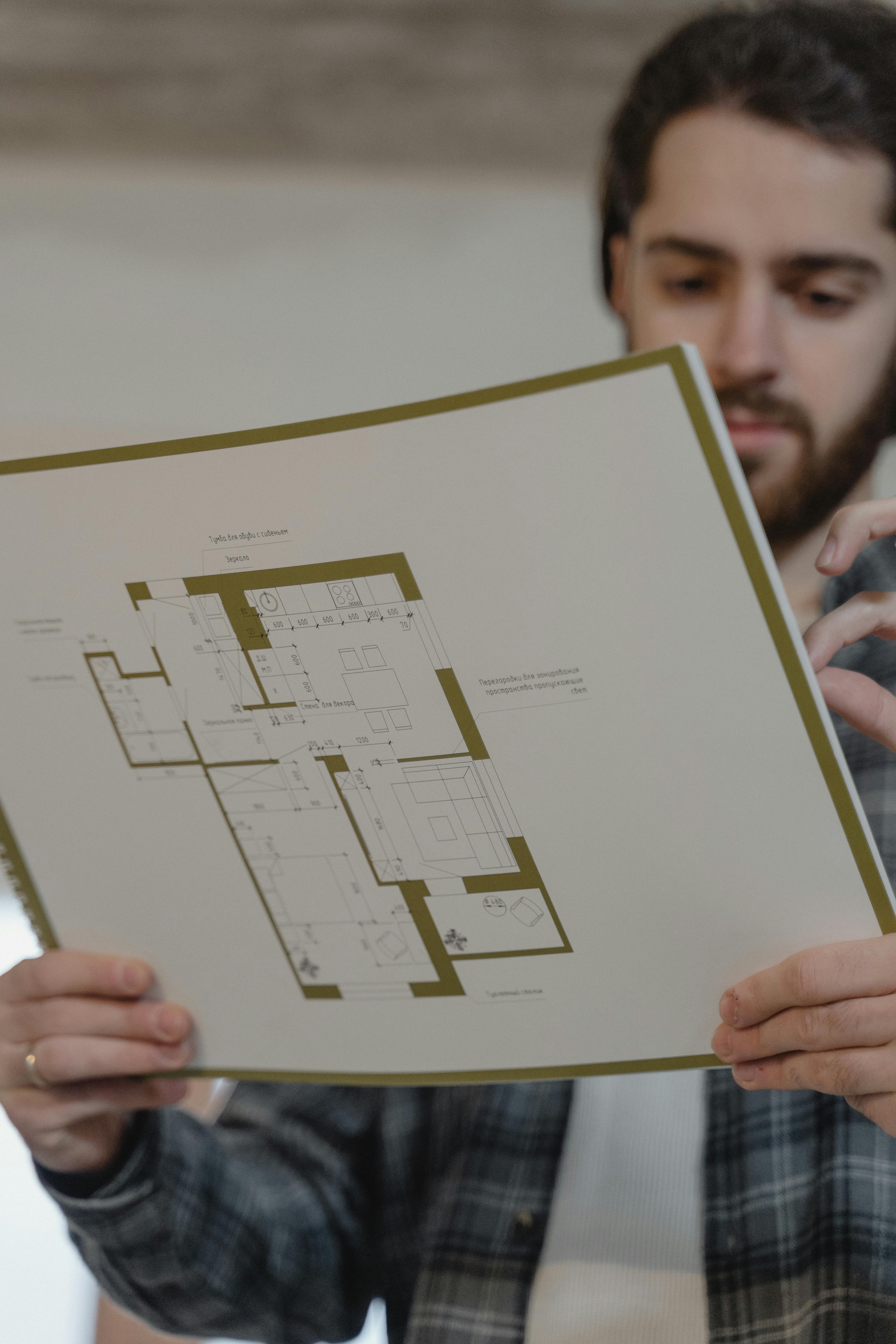 a man holding a floor plan