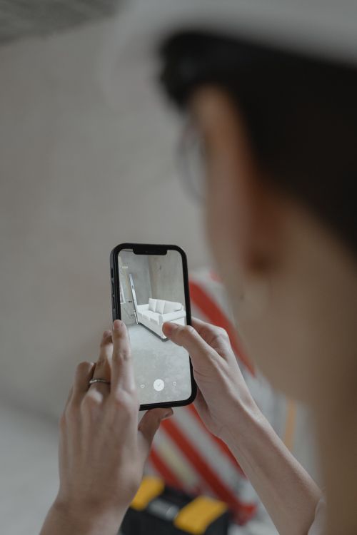 Free Person using augmented reality on smartphone to view furniture layout. Stock Photo