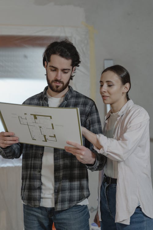 Free Couple Looking at the Blueprint Stock Photo