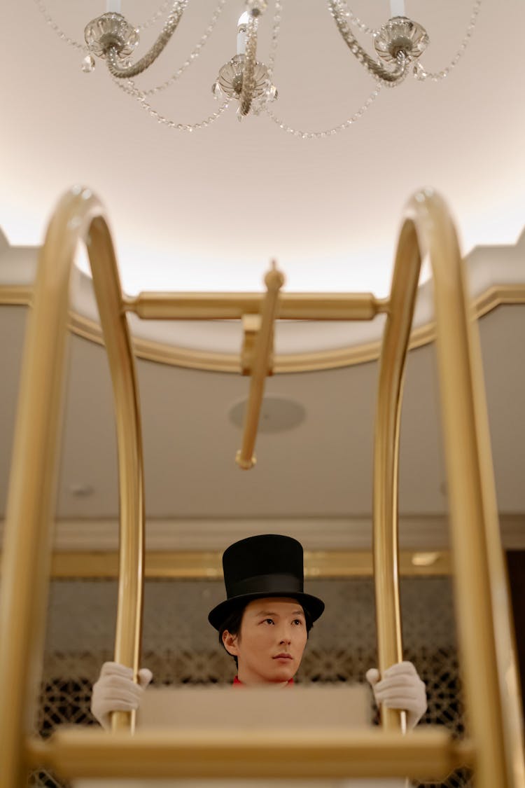 Man In Black Hat Pushing A Cart