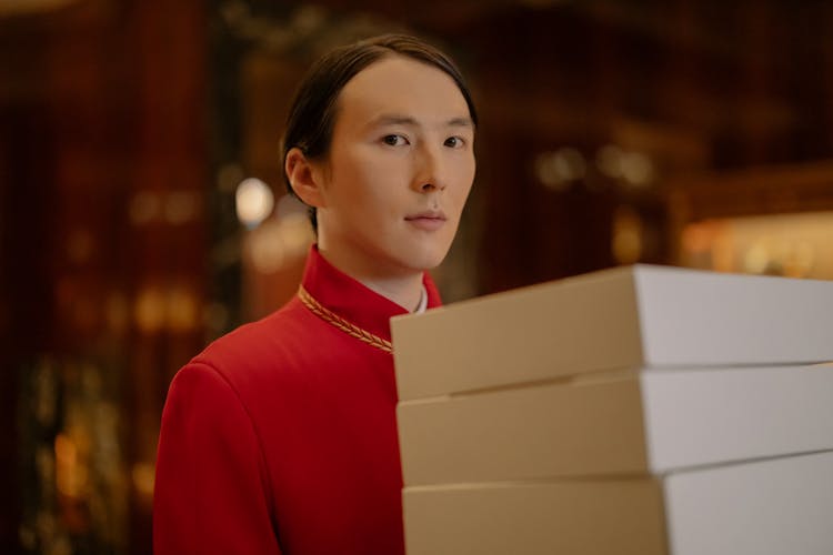 Man Carrying White Boxes