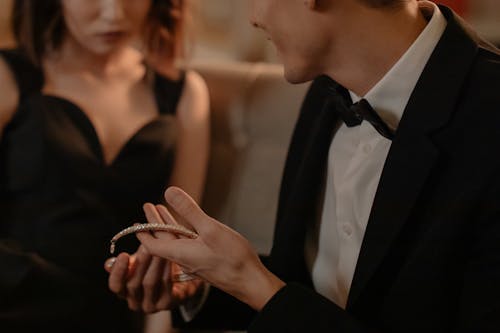 Free Man Showing the Diamond Necklace to the Woman Stock Photo
