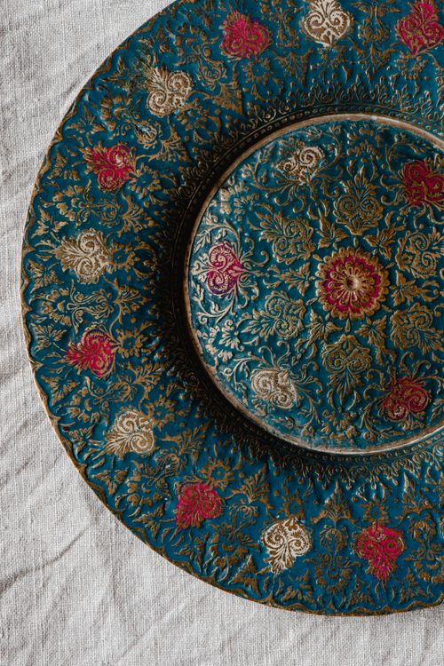 Free Close-up of a beautifully carved decorative plate with intricate patterns and vibrant colors. Stock Photo