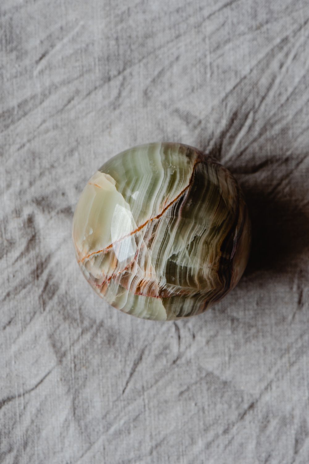 Green onyx stone with honey-amber banded translucency
