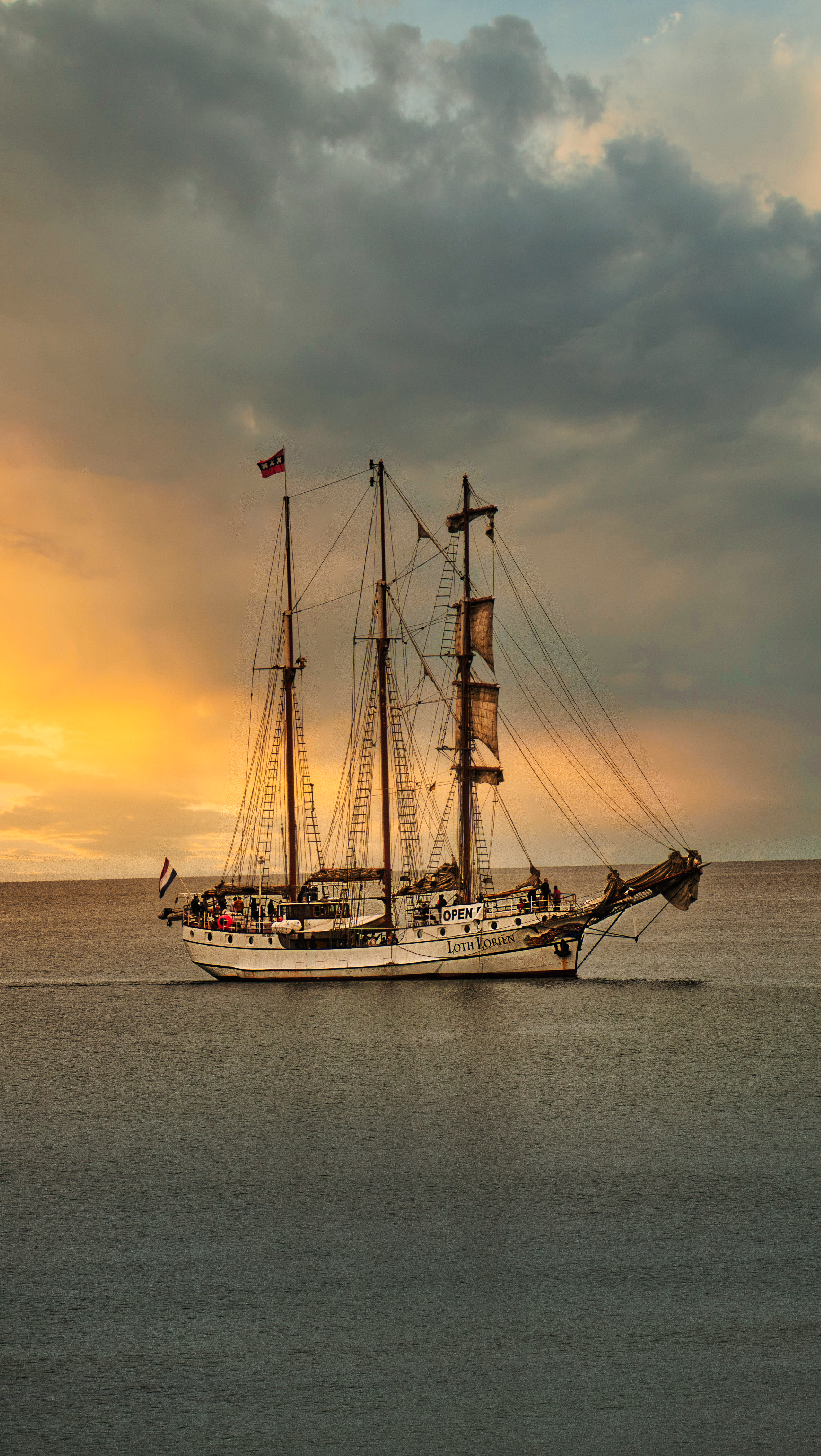 A Wooden Boat on the Sea during Sunset · Free Stock Photo