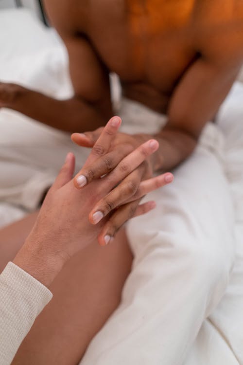 Close-up Shot of People Holding Each Others Hands