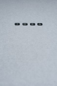 Minimalist text 'Idea' on gray background, perfect for creative concepts.