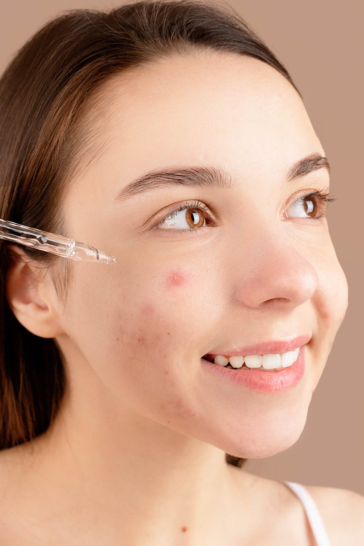 A Woman Applying Face Serum