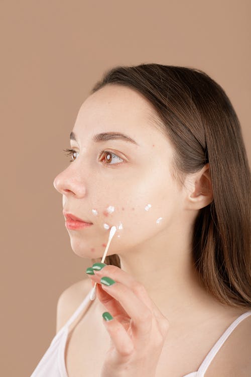 Free A Woman Applying Facial Cream Stock Photo