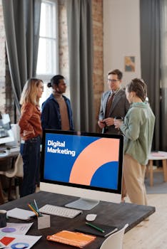 Business team engaged in a digital marketing discussion in a modern office setting.