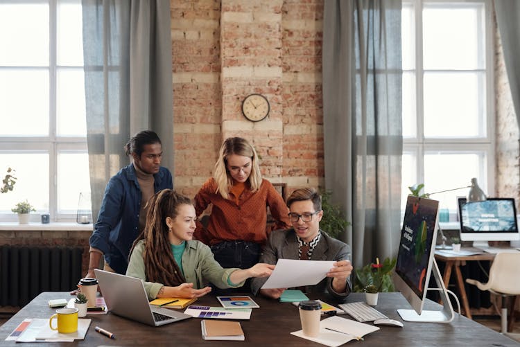 A Group Of People Discussing Marketing Plans