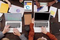 A Group of People with Graphs and Pie Charts on Table