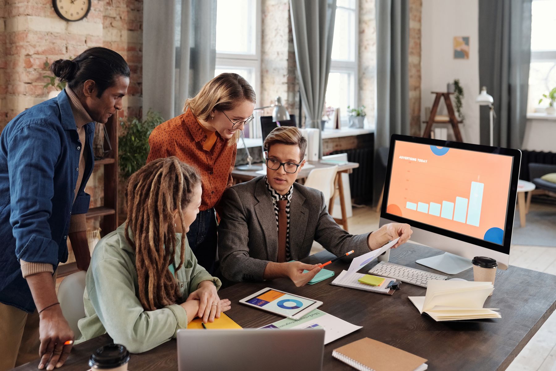 Marketing team reviewing campaign data and strategy together in an office