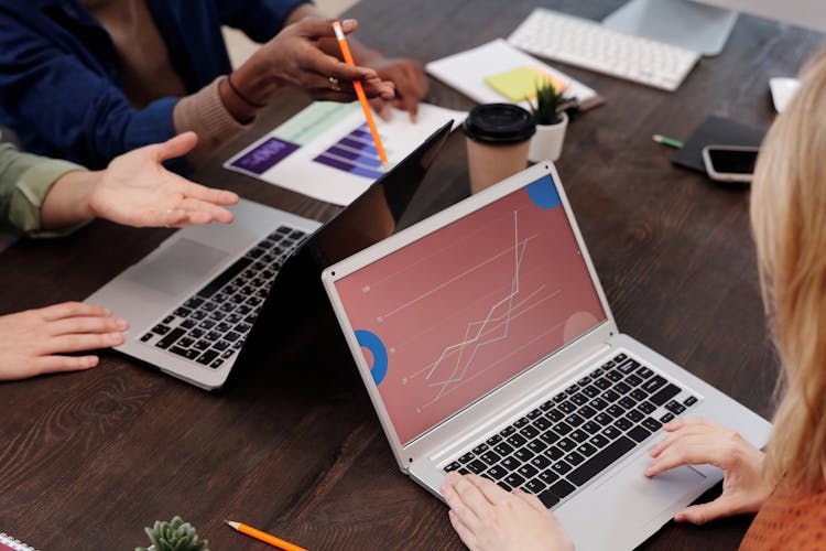 A Group Of People Using Laptops