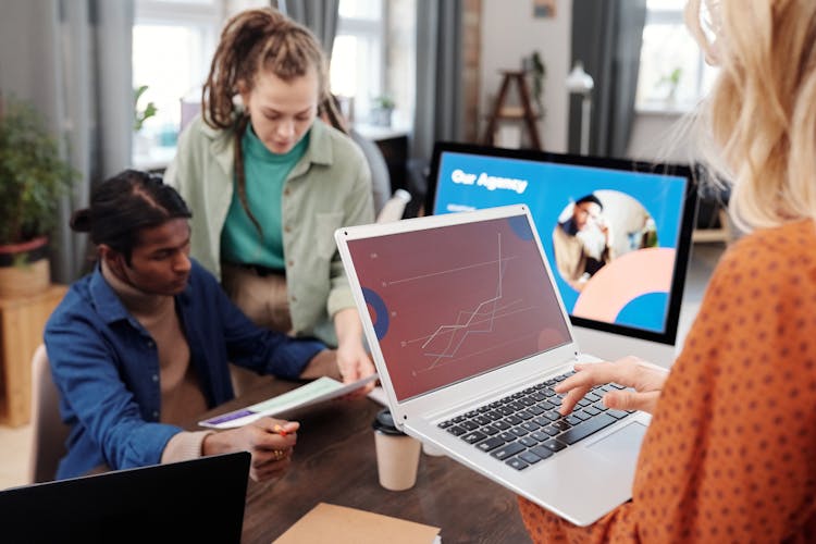 A Group Of People Using Laptops