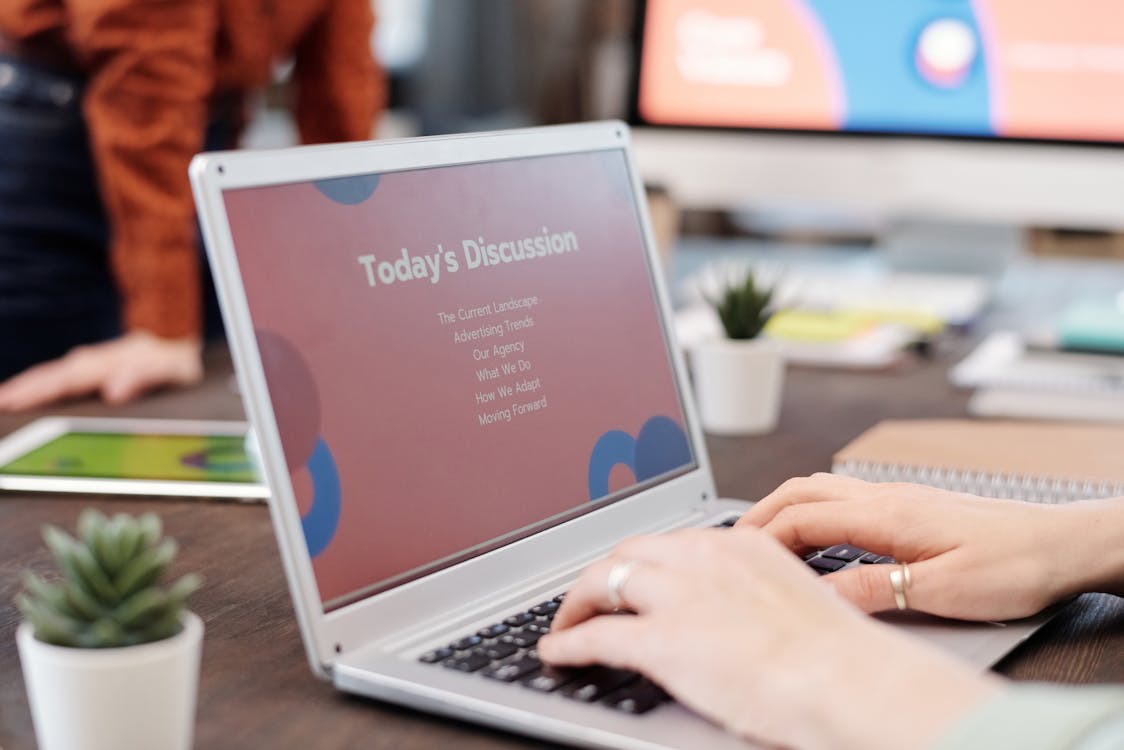 Free A Person Typing on a Laptop Stock Photo