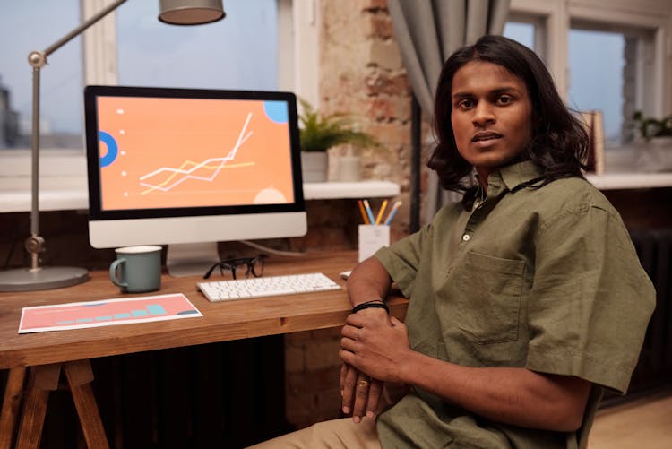 Man Sitting In Front Of His Computer