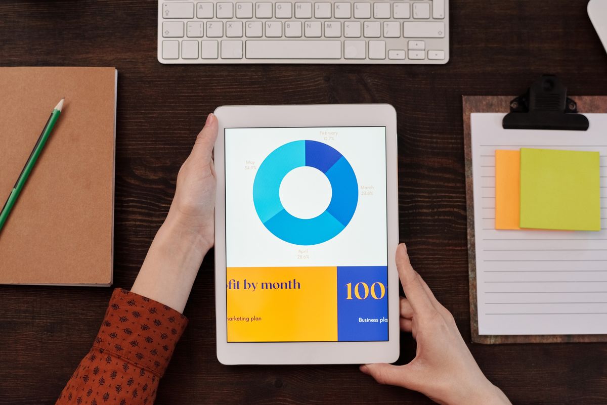 Tablet showing a data chart in someone's hands