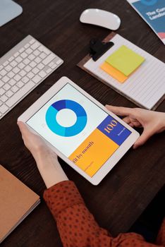 Modern office setting featuring a digital tablet displaying a graph, perfect for business presentations.