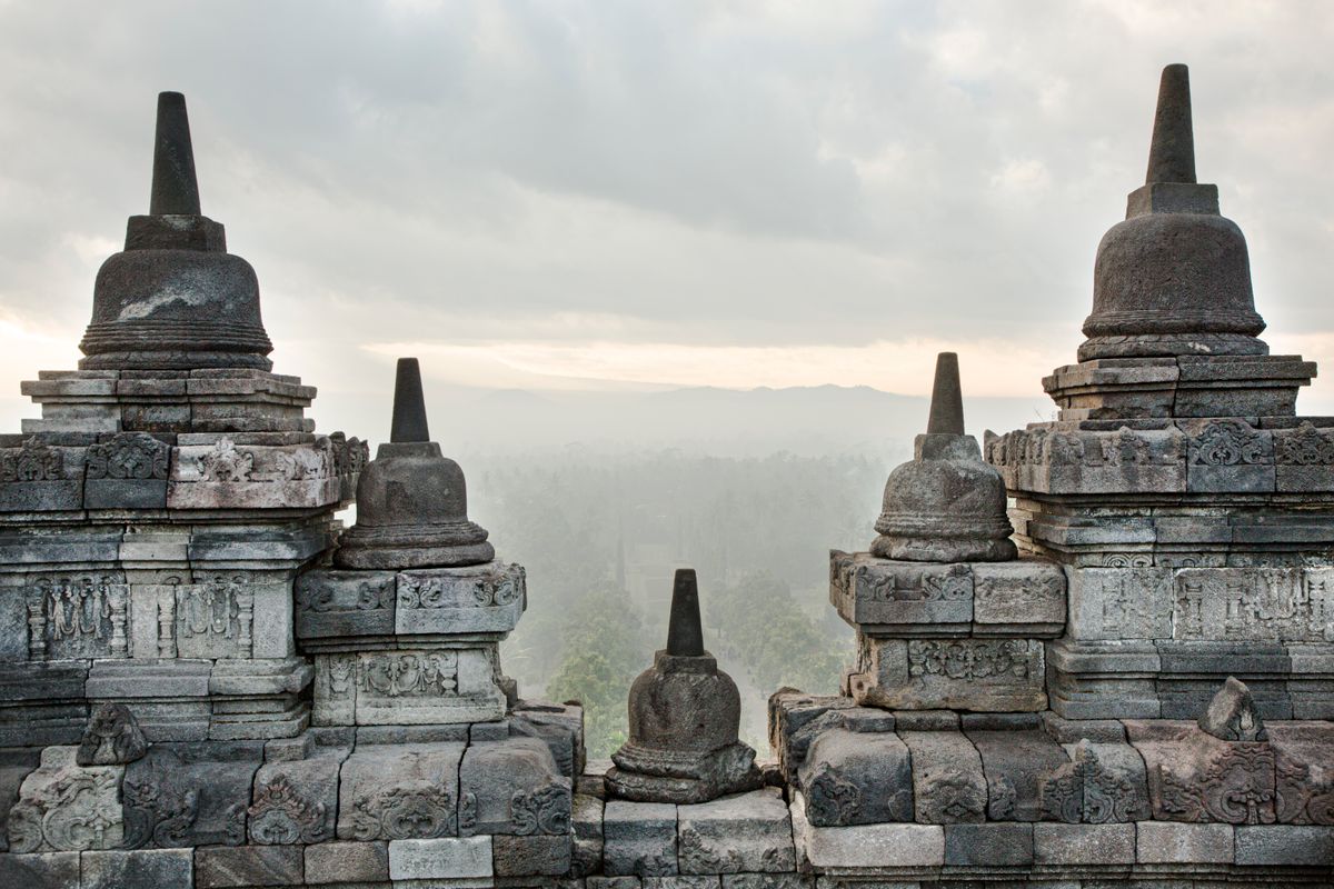 Borobudur's stupas at sunrise — the world's largest Buddhist temple, built in the 9th century.