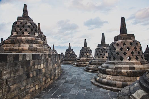 Stupas at Borobudur Temple in Indonesia, showcasing ancient Buddhist architecture.