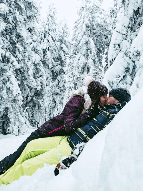 Couple Kissing while Lying on the Snow