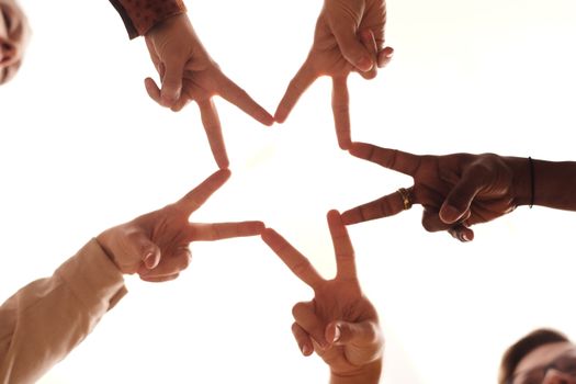 A group of diverse hands forming a star shape, symbolizing unity and friendship.