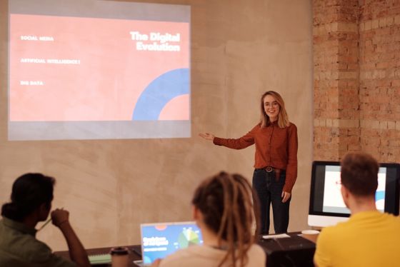 A pitch being presented to a seated room, photo by Mikael Blomkvist on Pexels