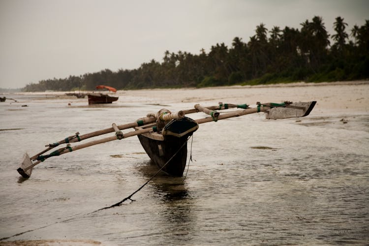 Fishing Boat On Water Of River In Zanzibar