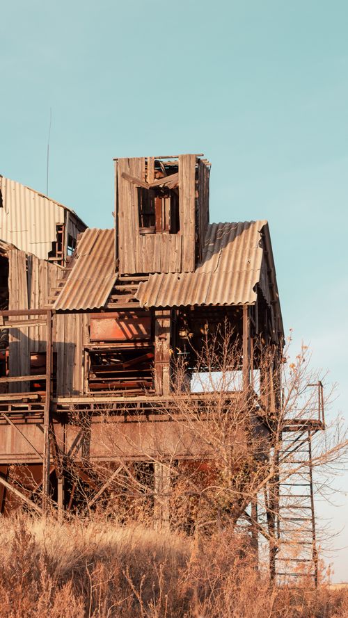Free A weathered and abandoned building in rural Nikol'skoye, Russia under clear skies. Stock Photo