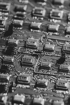 High-detail black and white image focusing on microchips on a circuit board.