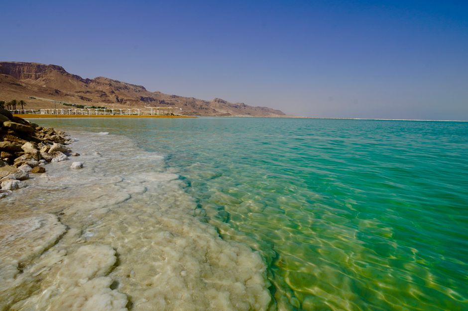 Tourists floating in the Dead Sea under a bright sunny sky in Israel