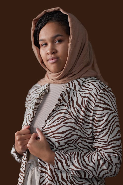 Person in Brown Hijab and White and Brown Stripes Long Sleeve Shirt