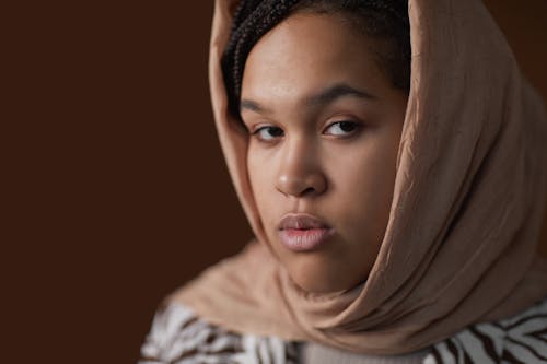 Woman in Brown Hijab With Brown Background