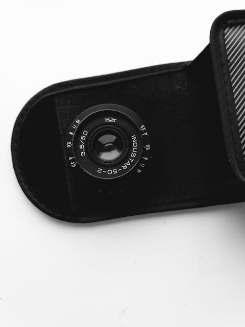 Black Camera Lens on White Surface