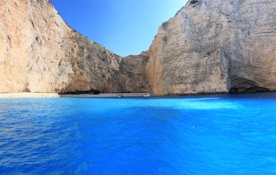 Discover the breathtaking turquoise waters and iconic shipwreck at Navagio Beach in Zakinthos, Greece.