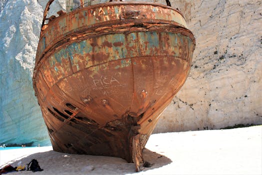 Explore the iconic rusty shipwreck at Navagio Beach in Zakinthos, Greece, against stunning cliffs.