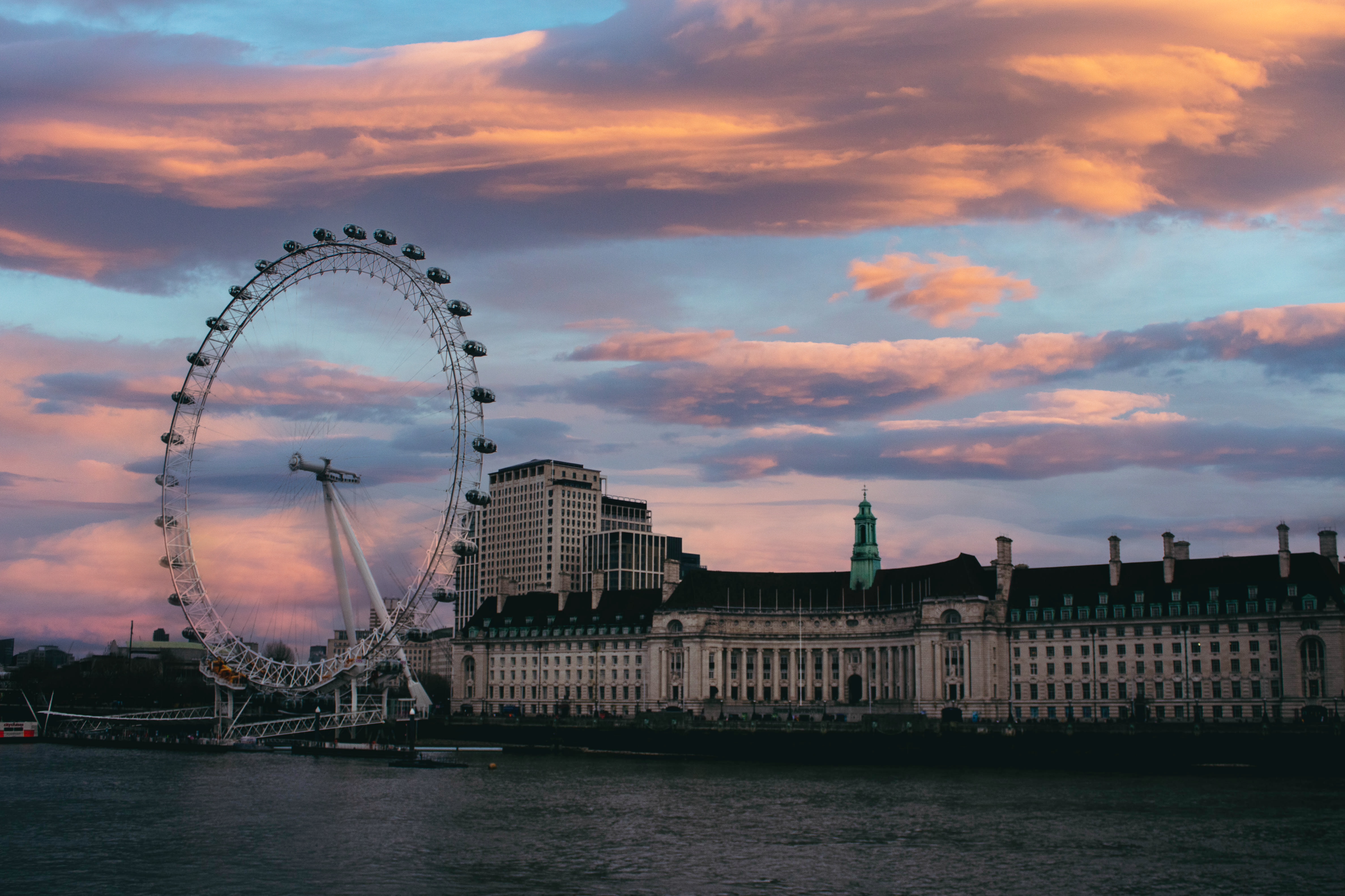 Captivating sunset view of the London Eye and riverside architecture, perfect for travel and tourism themes.