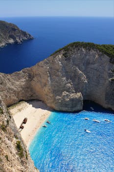 Stunning aerial shot of Navagio Beach in Zakynthos, featuring a famous shipwreck and turquoise waters.