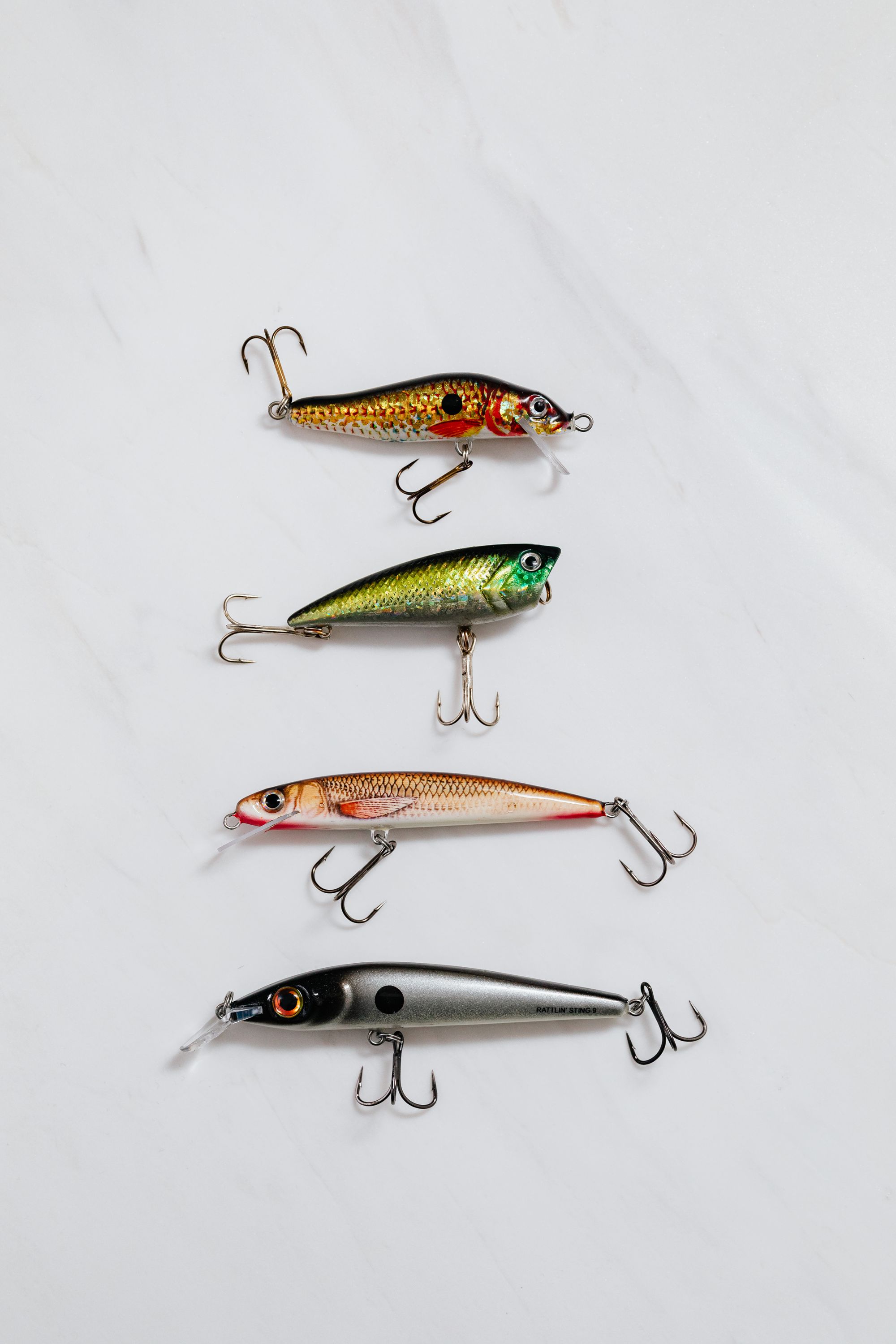 Colorful fishing lures arranged in a top-view equipment layout