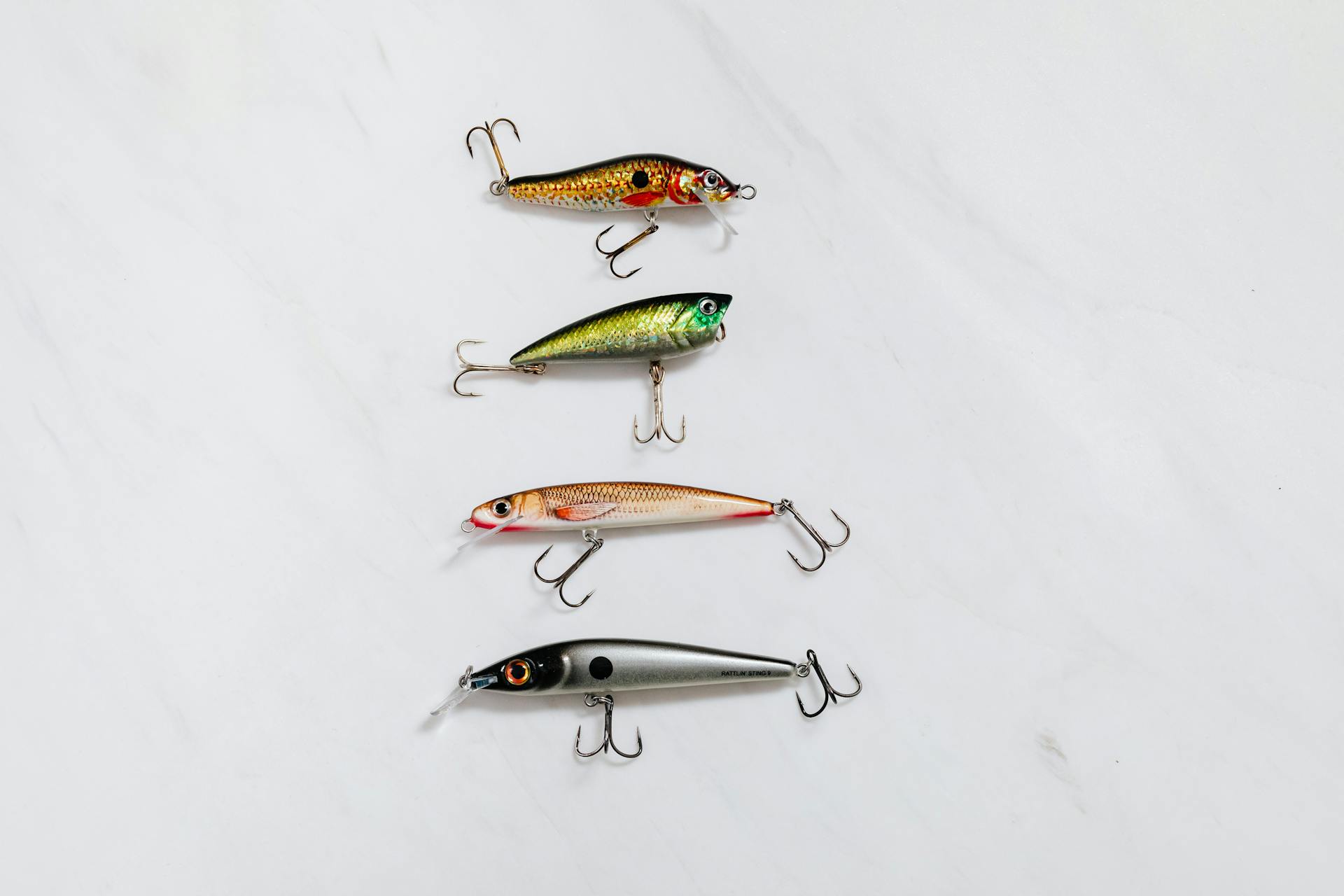 Fishing Lures Arranged on White Surface