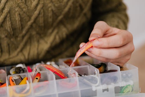 Close Up Photo of Hand Holding a Fishing Lure