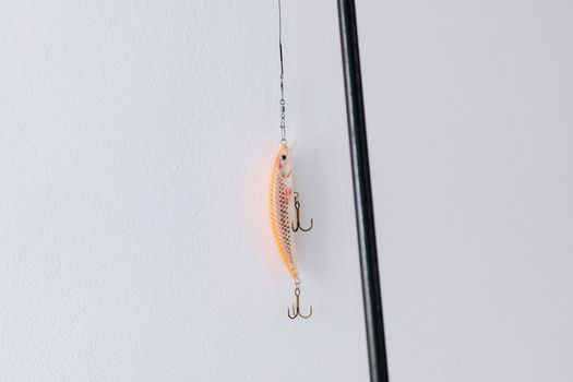 Detailed close-up of a fishing lure attached to a fishing rod, perfect for angling or fishing enthusiasts.