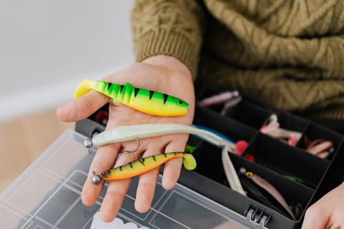 Assorted Fishing Lures on a Person's Hand