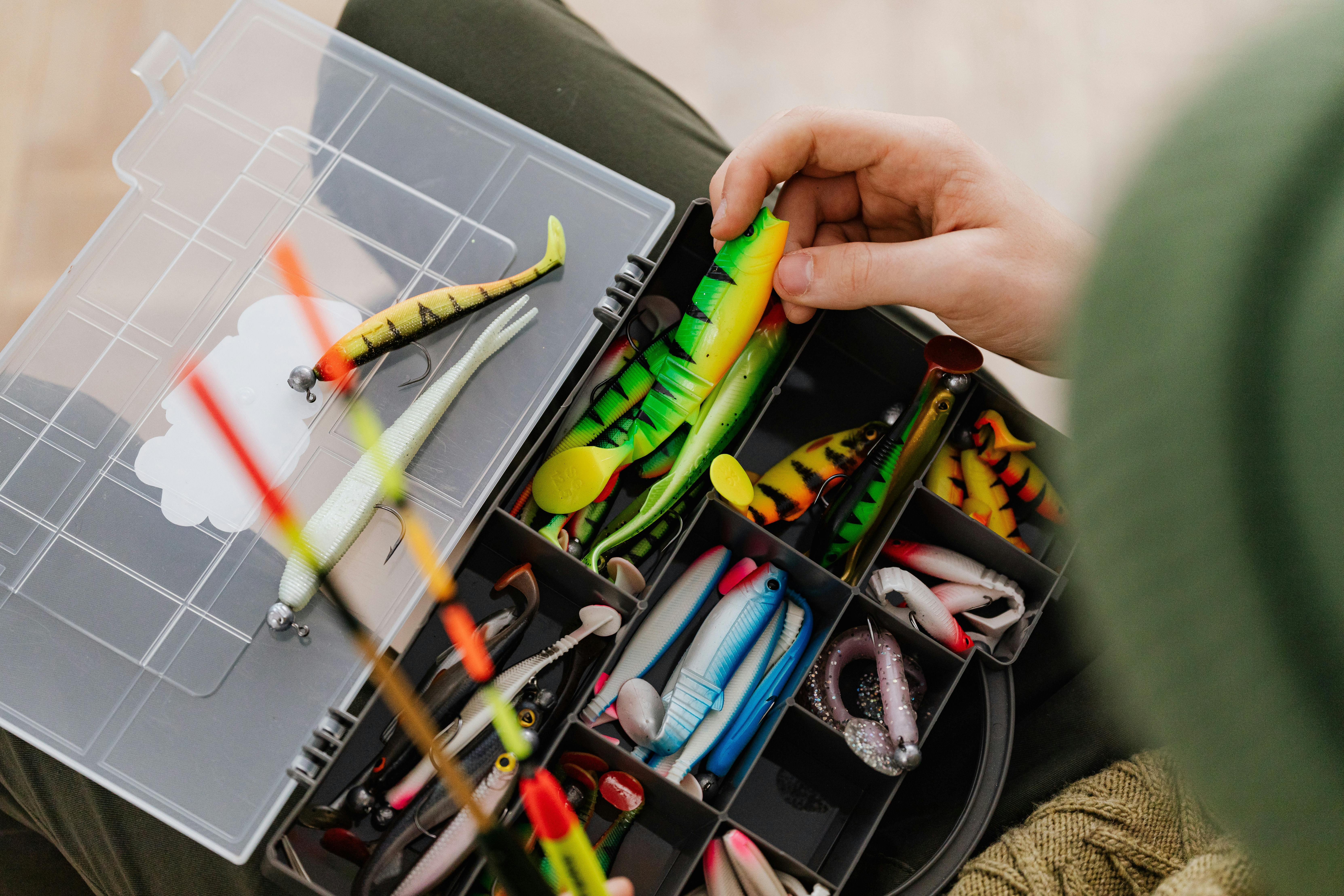 Close-up of colorful fishing lures organized in a tackle box. Perfect for anglers.